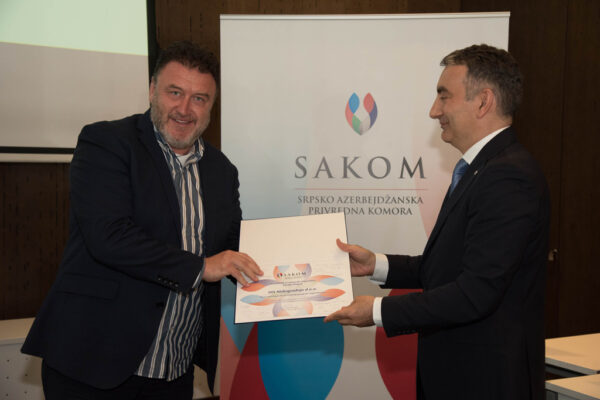 48 Mr. Saša Pavlović, the newly-elected SAKOM Board Member and Representative of DIS Niskogradnja receiving the certificate of appreciation and Duboki Potok Monastery’s brandy (rakija).